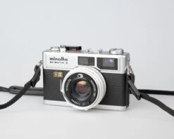 Minolta Hi-Matic E Compact 35mm Rangefinder Camera Feat. 40mm F1.7 Rokkor Lens (serial 328710)(Minolta Hi Matic E Compact 35mm Rangefinder Camera Feat 40mm F1 7 Rokkor Lens Serial 328710) -Vintage Camera Store minolta hi matic E 35mm rangefinder camera serial 328710 202304213780